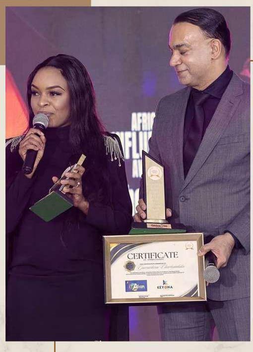 Gamuchirai and Walter Gode receiving the 2022 award on stage